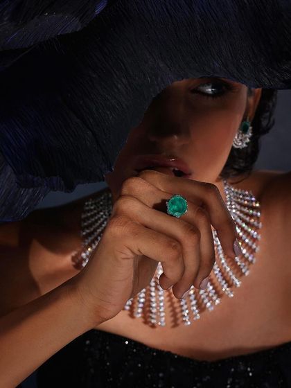 A mysterious and elegant shot for Purab Paschim, with a large hat obscuring part of the face to draw attention to the emerald ring and diamond necklace.