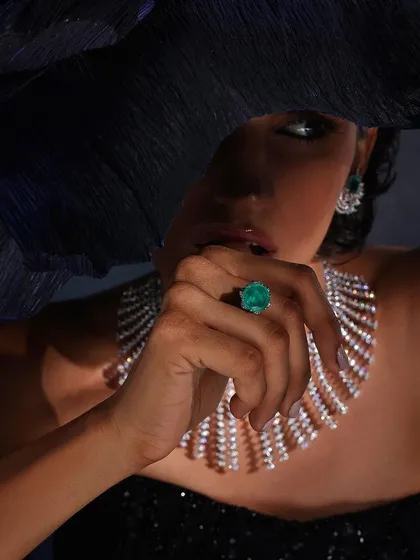 A mysterious and elegant shot for Purab Paschim, with a large hat obscuring part of the face to draw attention to the emerald ring and diamond necklace.