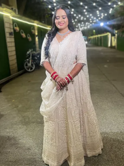 Grace, glamour, and a touch of sparkle. This reception look in an all-white lehenga is perfect for making a statement.