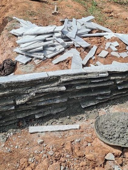 A local artisan works on a mock-up wall for the Nandi Hills house, carefully laying the thin granite off-cuts. This process relies on the skill of local craftspeople.
