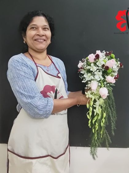 This student's smiling face says it all. She is holding her beautifully constructed cascading bouquet, a design that requires skill in wiring, taping, and creating a natural flow.