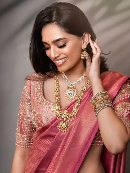 A candid-style bridal shot that captures a moment of joy. This approach brings a natural and relatable feel to bridal lookbooks, highlighting the beauty of the attire in a more personal way.