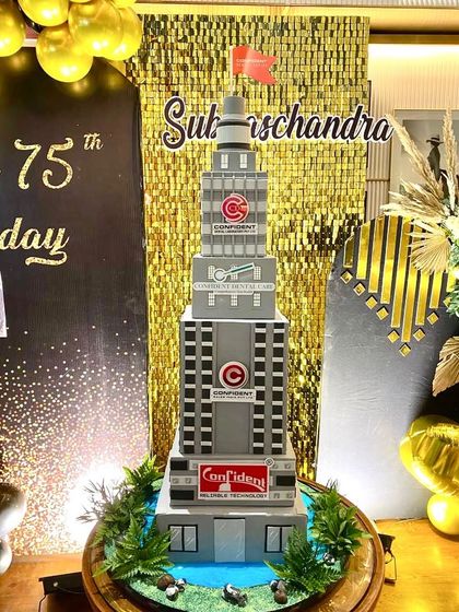 The full view of the massive building cake, set up at the 75th birthday party.