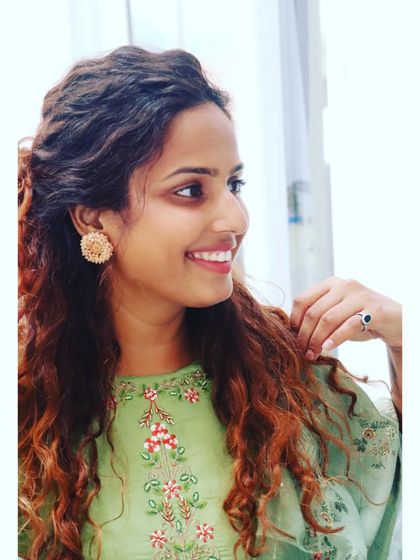 A close-up showing how simple stud earrings can complement an embroidered neckline without overpowering it. It's all about balance in personal styling.