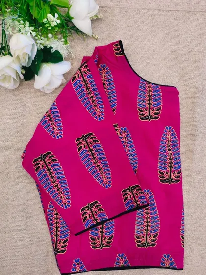 A pure cotton boatneck ready-made blouse in a vibrant pink with a traditional printed design.