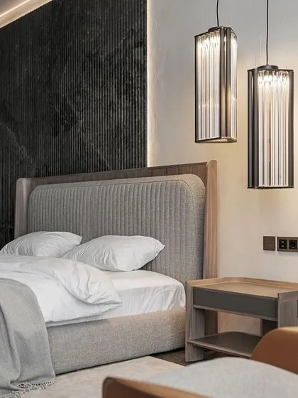 Perfection in simplicity. This bedroom design features our custom bed with a vertically channeled grey headboard and a matching wood-finish frame, creating a calm, contemporary, and sophisticated look.