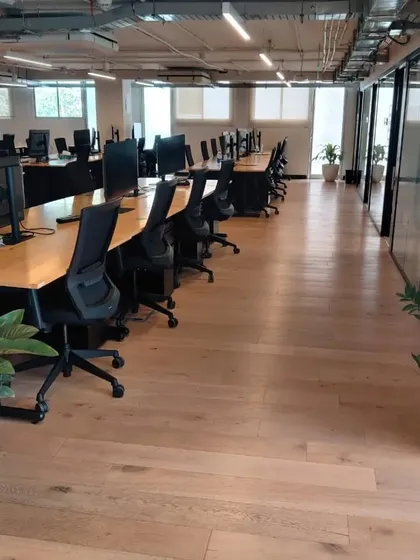 A look at how we integrate greenery into large office spaces. Strategically placed plants in clean, white planters enhance the work environment without disrupting the office flow, improving air quality and aesthetics.
