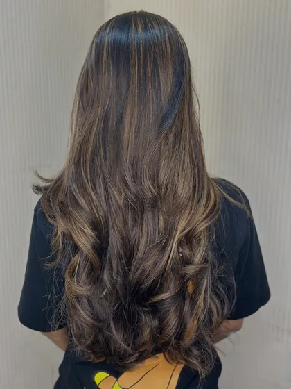 From the back, you can really see the artistry in the balayage placement. Each strand is painted to contribute to the overall dimensional look.