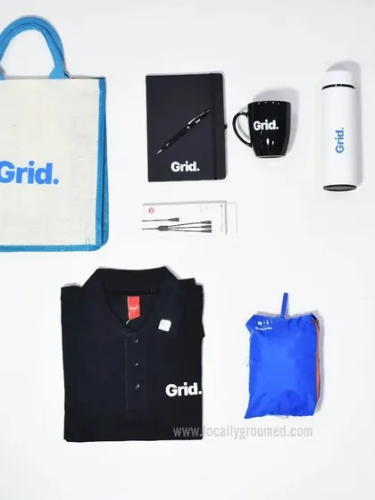 This practical and stylish onboarding kit for Grid features a branded polo shirt, a jute tote bag, a notebook and pen, a water bottle, and a foldable rain jacket, covering all the essentials for a new team member.