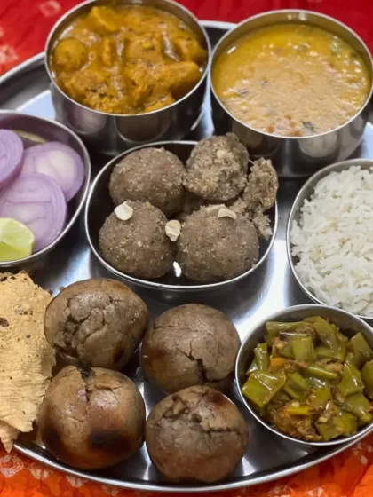 A complete homemade-style Rajasthani thali, offering a balanced meal with a variety of textures and flavors.