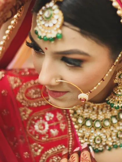 An elegant bridal portrait focusing on the fine details of the nath (nose ring) and traditional jewelry. This style of photography highlights the timeless beauty and grace of the bride on her wedding day.