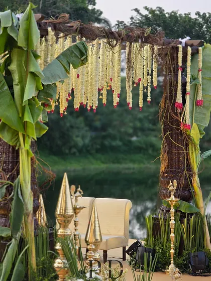 For this South Indian wedding, we designed a rustic-luxe mandap using banana leaves, woven vines, and hanging tuberose garlands. The design honors tradition while feeling fresh and integrated with the natural surroundings.