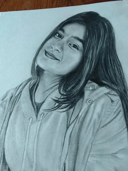 A casual portrait of a young woman in a hoodie. I can create a realistic sketch from any of your favorite photos.