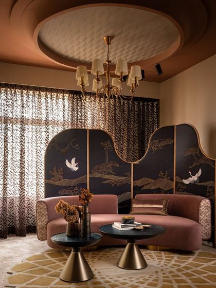 Another view of the lounge area in Zone Four, showcasing the elegant curves of the custom sofa and the hand-embroidered partition screen. The design plays with a sophisticated palette of mauve, mustard, and deep blue to create a calm yet characterful space.
