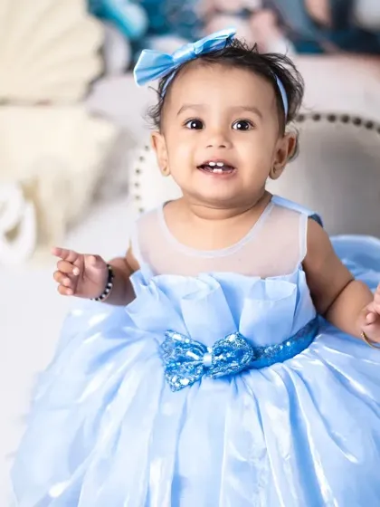 A beautiful princess in blue celebrating her first birthday. We have a wide selection of gorgeous dresses for baby girls.