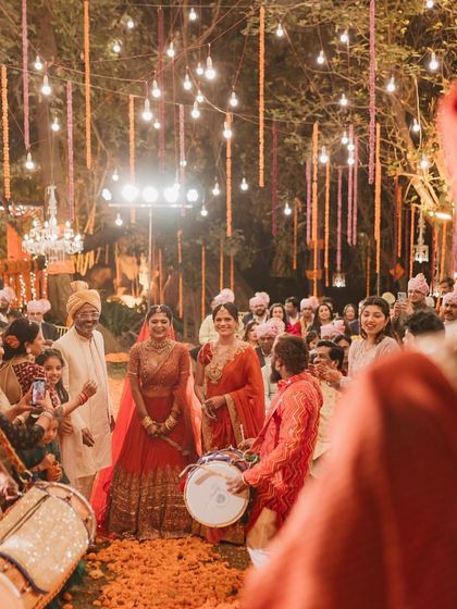 The groom's first look as his bride enters, surrounded by the energy of dhol players and happy guests. We choreograph these key moments to maximize their emotional impact and create a beautiful memory.