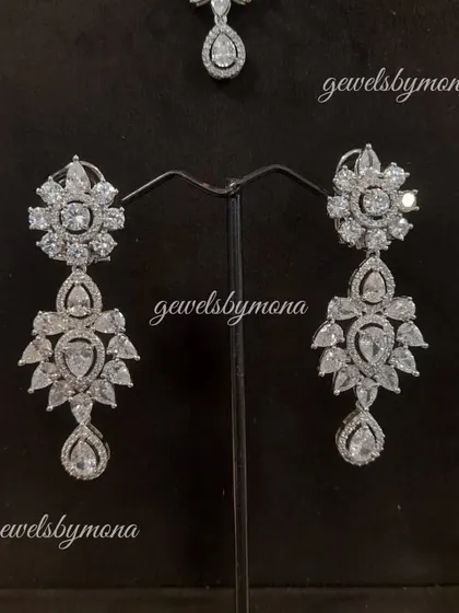 A detailed view of the floral-inspired diamond earrings from our bridal set. The intricate design and brilliant diamonds make these a stunning choice for a bride who wants to shine.