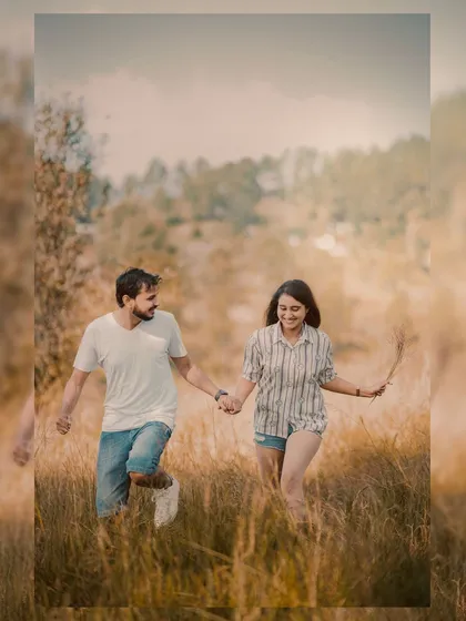 A happy, carefree moment of the couple running through a field in Uttarakhand. This shot captures pure joy and movement, showing that pre-wedding photos can be dynamic and full of life.