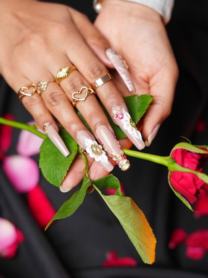 This pose with a rose complements the romantic theme of the nail art perfectly.