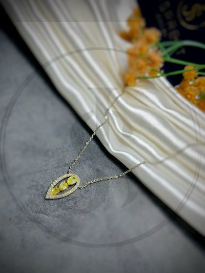 I designed this pendant to feel like a captured piece of sunlight. A rare yellow diamond is set within a teardrop-shaped frame of white diamonds, creating a piece that glows with warmth and positivity.