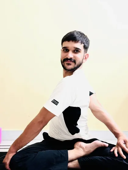 A deeper variation of the seated spinal twist, demonstrating how the pose can evolve with practice.