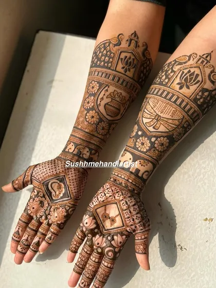 This bridal design is a beautiful mix of many elements. It has custom symbols in the palms, elephants and kalash motifs on one arm, and a shehnai on the other.