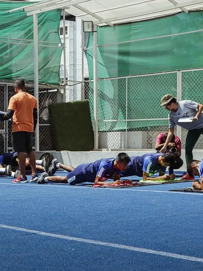 Core work and foundational strength are non-negotiable. Here, the SCB team works on planks and other stability exercises under the watchful eye of the coaching staff.