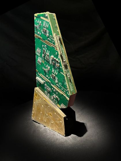 This unique award is shaped from a motherboard and other electronic components, mounted on a sturdy base. It's an example of how I can create custom, sustainable trophies for any event.