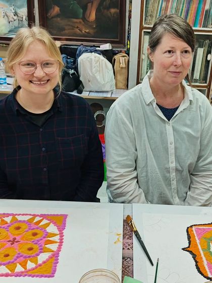 Two of our international participants with their beautiful, finished rangolis. We are proud to be a global destination for art lovers.