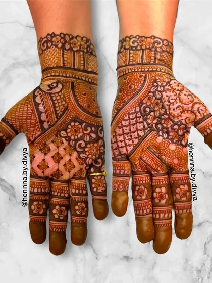 This intricate Indian mehendi design is filled with a variety of patterns, including floral, paisley, and jaali work. The asymmetry gives it a modern and artistic feel.
