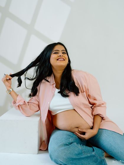 A playful, happy moment captured in the studio. Her genuine smile and relaxed pose make this such a heartwarming and authentic portrait.