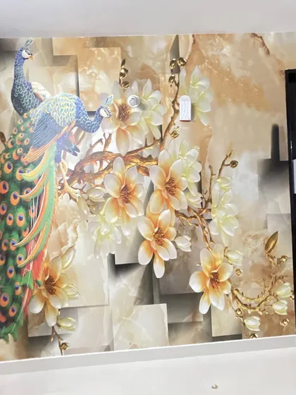A finished installation of a 3D wallpaper featuring a peacock and flowers on a textured, geometric background. The design is rich in color and detail.