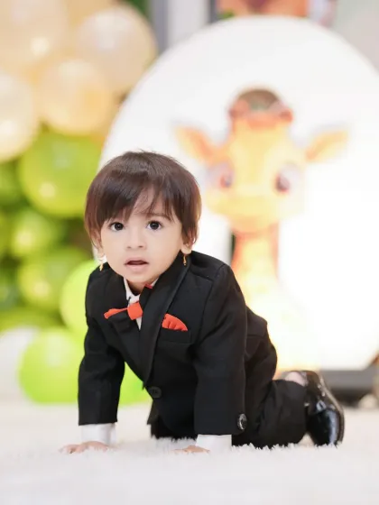 A playful, candid shot of the birthday boy crawling on a soft rug during his party. I am always ready to capture these adorable, spontaneous moments.