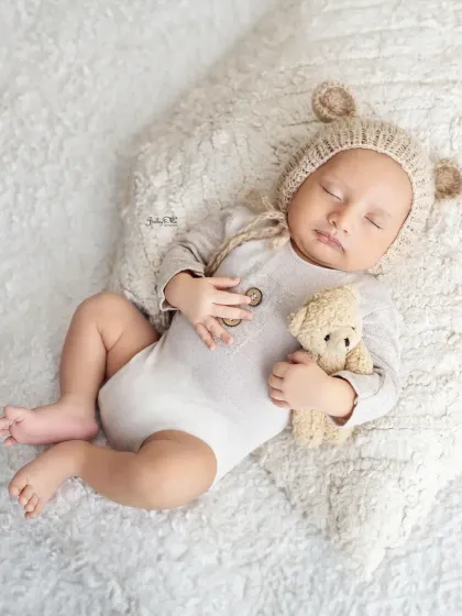 A tiny bear hat for a tiny sleeping bear. Using cute, themed accessories like this is a simple way to add a playful touch to a classic newborn session.