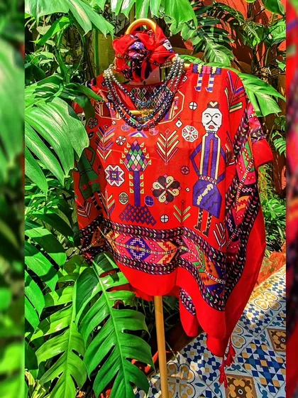 Another look at the red folk-art kaftan top, styled with a shaded pearl and crystal necklace. This shows how you can accessorize the same piece differently for a whole new vibe.