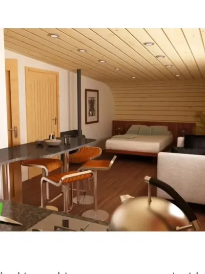 This unique "log-like" cabin design shows our creative potential. The exterior is a loop of shingles, while the interior is a cozy, fully-equipped living space with a kitchen, bed, and seating area.