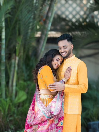 A warm embrace in a beautiful garden setting. This photo captures a quiet, tender moment during their colorful pre-wedding photoshoot.