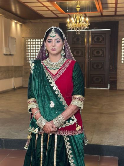 A full-length view of the stunning Rajasthani Poshak, the rich colours of the outfit are complemented by a regal makeup look.