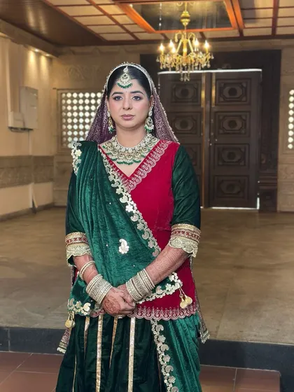 A full-length view of the stunning Rajasthani Poshak, the rich colours of the outfit are complemented by a regal makeup look.