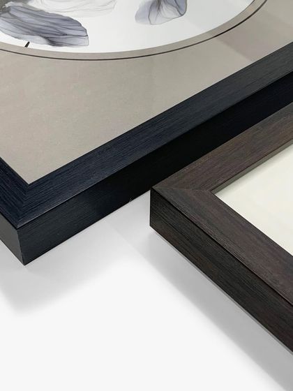 These enchanting floral masterpieces are elegantly showcased in stunning black wooden frames. The unique round mat design adds a soft, creative touch that sets them apart.