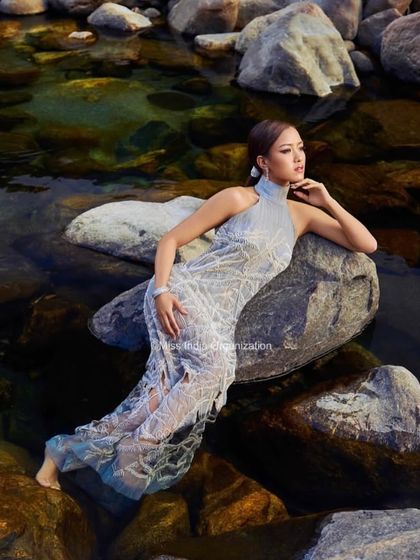 A serene and powerful image of a Femina Miss India queen. We created a sleek, wet-look hairstyle to complement the high-fashion gown and the natural water element of the shoot.