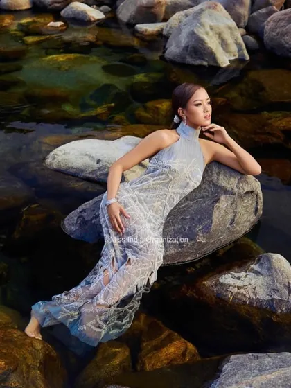 A serene and powerful image of a Femina Miss India queen. We created a sleek, wet-look hairstyle to complement the high-fashion gown and the natural water element of the shoot.