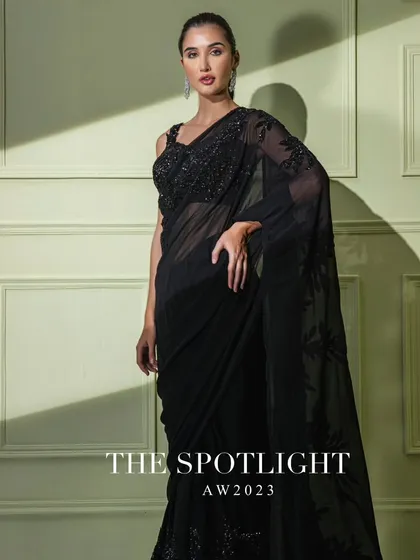 A campaign shot of the black floral embroidered saree, a timeless piece from "The Spotlight" collection.