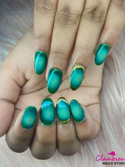 An absolutely stunning emerald green cat-eye effect gives these nails a deep, mysterious shimmer. We added a gold chrome accent on the cuticle of one nail for a touch of unexpected luxury.