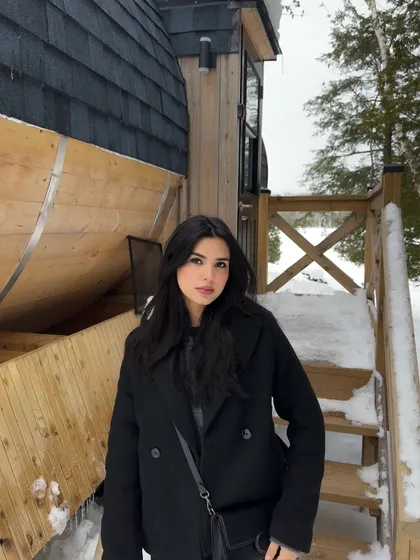 A close-up portrait in the snow, focusing on my expression and the cozy winter vibe.