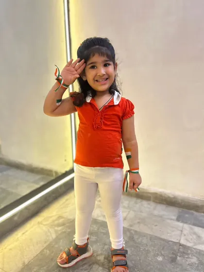 Another one of our little stars saluting the flag with a big smile. We prepare kids for school functions and community events for all national holidays.