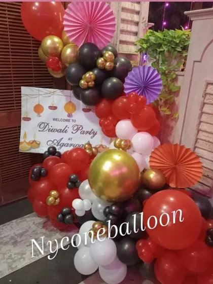 Another angle of the Diwali party entrance decor, showing the mix of balloons and paper fans used to create a full and festive look.