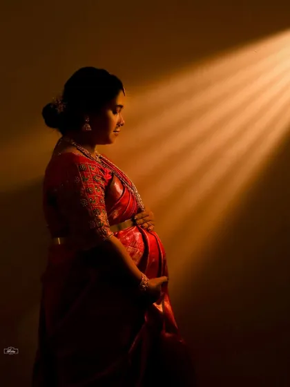 A powerful and artistic portrait celebrating the quiet strength of motherhood. We use creative lighting techniques in our studio to craft these dramatic and soulful images.