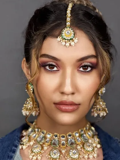 A modern take on bridal, pairing a denim jacket with traditional jewelry. This teaches students to think outside the box.