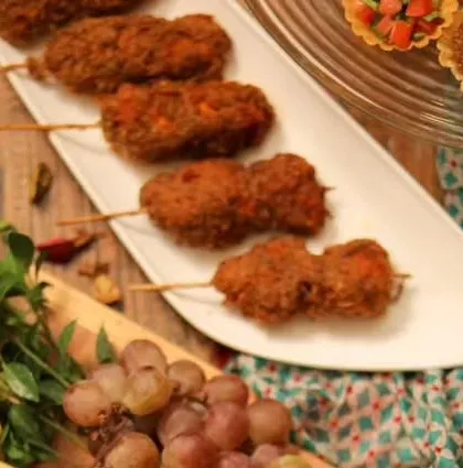 A close-up of my crispy chicken lollipops on skewers, ready for plating. This is a popular pass-around appetizer at parties.